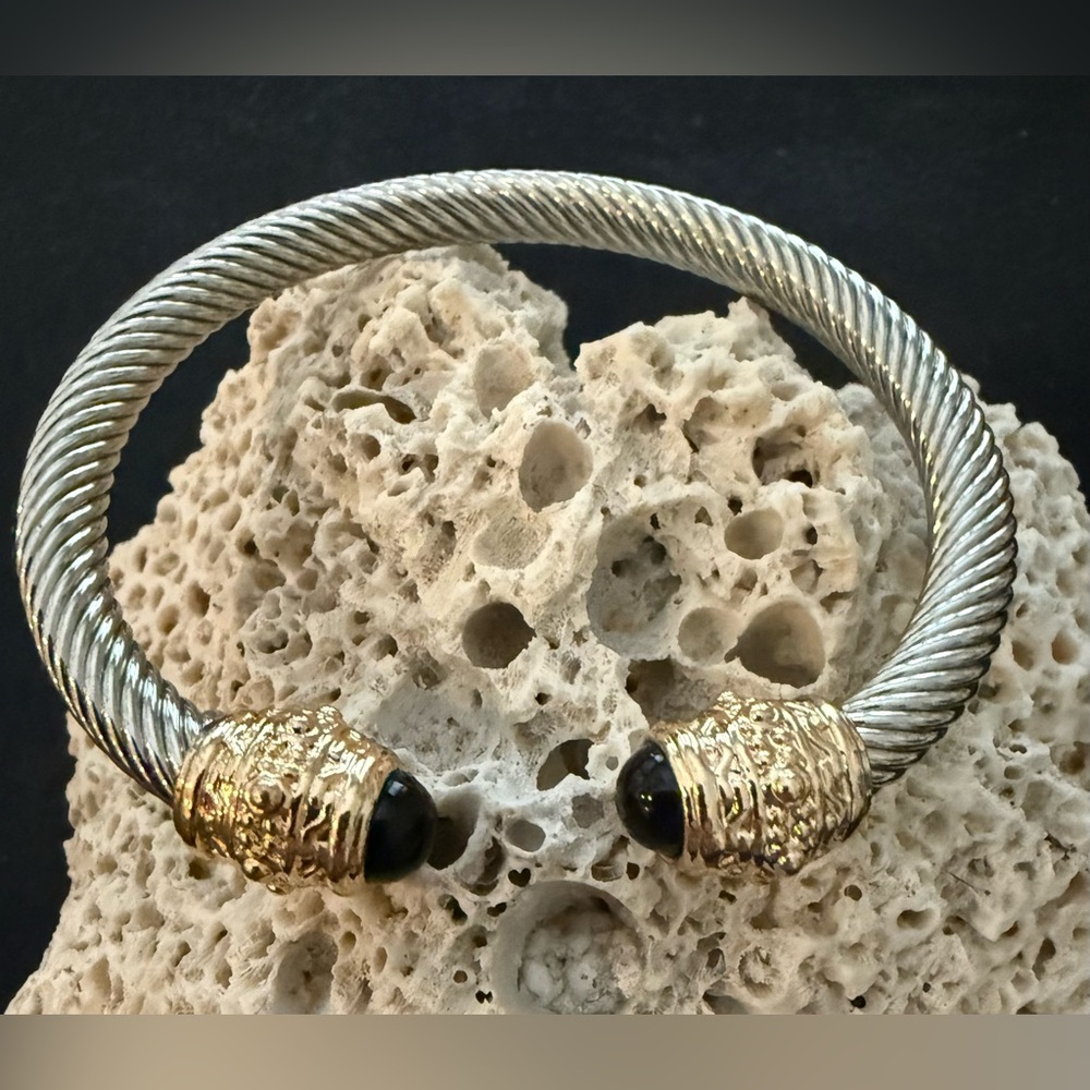 Truly stunning designer style bangle. Stainless/gold tones/black stones.